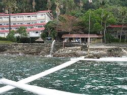 Anilao - Eagle Point beach resort; duikschool met naastgelegen resorthotel vanaf de boot